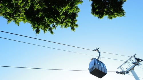 Cable Car Moving Along Cable in Urban Area