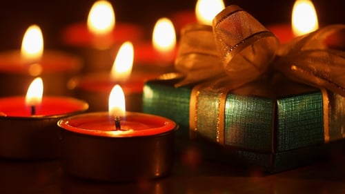 Small Gift with Candles Glowing in the Dark