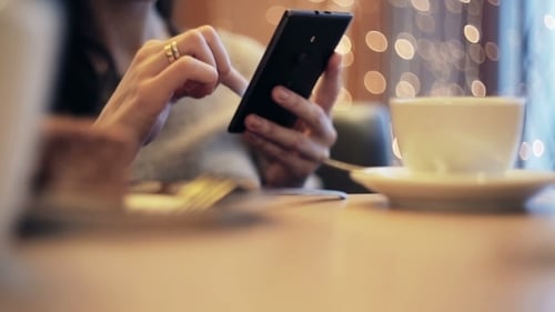 Woman Hands Texting, Using Smartphone In Cafe.