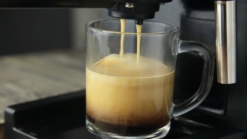 Espresso Machine Pouring Coffee into Glass Mug