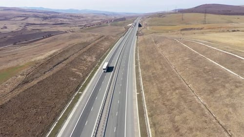 Cars and Trucks Passing on a Highway