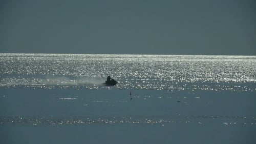 A Couple On a Jet Ski In The Ocean