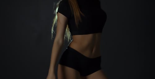 Young Woman Dancing in Studio with Expressive Rhythm