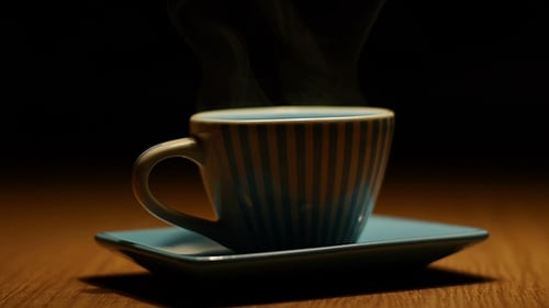 Steamy Cup of Coffee on Saucer