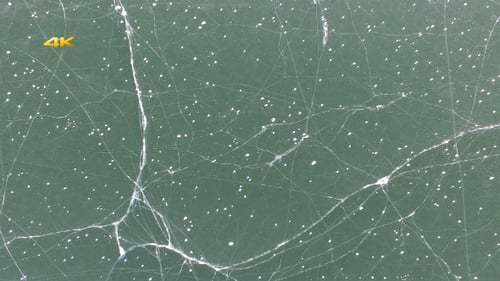 Aerial View of Cracking Ice on Frozen Lake