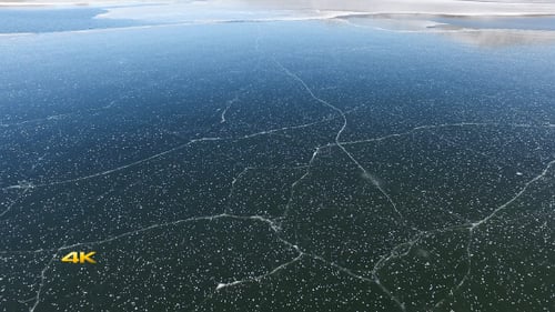 Aerial View of Cracked Ice on a Frozen Lake