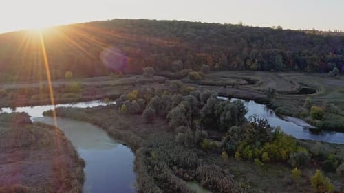 Scenic View of Curvy River Among Meadows at Sunset in Autumn