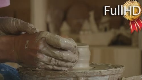 Person Shaping Clay on Potter's Wheel