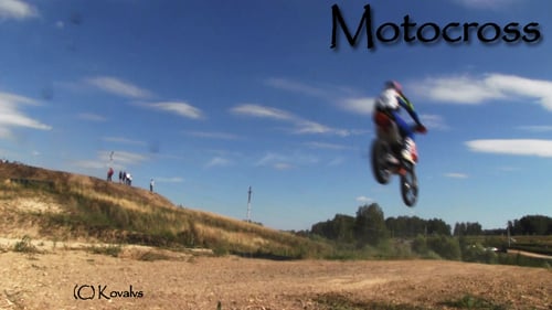 Motorcyclist Jumping on Rural Dirt Track on Sunny Day