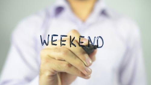 Writing the Word Weekend on Clear Surface