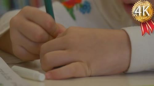 Child Drawing with Green Marker Close Up