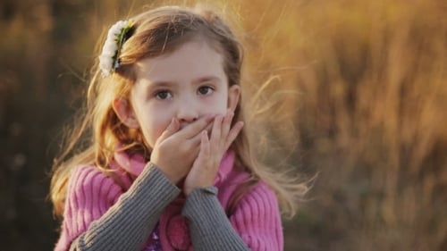 Cute Girl Making Hand Gestures Outdoors