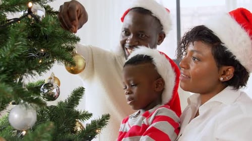 Happy Family Decorates Christmas Tree at Home