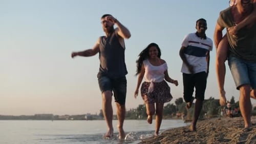 Happy Friends Running on Beach