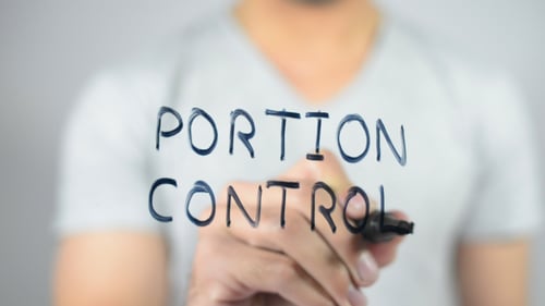 Hand Writes Portion Control with Black Marker