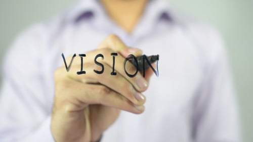Hand Writes the Word Vision with a Marker