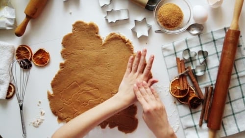 Cutting Festive Holiday Sugar Cookies in Kitchen Flat Lay