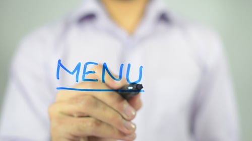 Hand Writes the Word Menu with Blue Marker