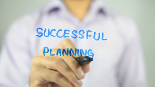 Adult Writes Successful Planning on Clear Surface