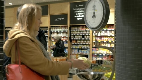 Man And Woman Weighing Cabbage