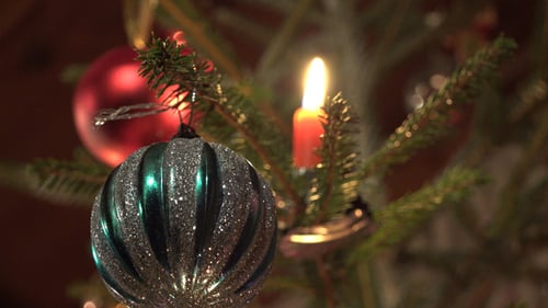 Christmas Tree Ornaments and Candle Close Up