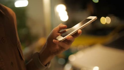 Adult Using Phone at Night Close Up