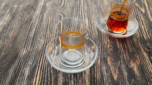 Black Tea Poured Into Glass on Wooden Table
