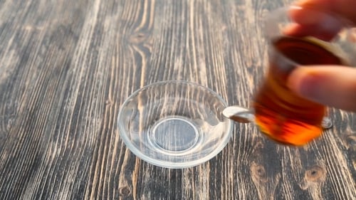 Preparing Hot Tea Beverage in Glass Cup