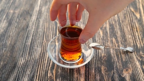 Steaming Tea in a Glass on Wooden Table