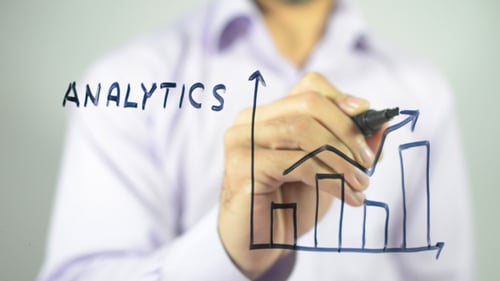 Man Drawing Analytics Chart on Transparent Surface