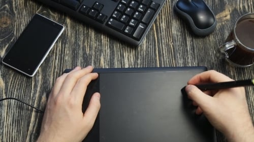 Graphic Designer Using Digital Tablet at Workspace