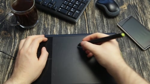Designer Using Graphics Tablet at Desk Overhead