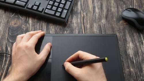 Using Tablet and Stylus on Wooden Desk