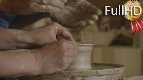 Hands Shaping Clay on a Pottery Wheel