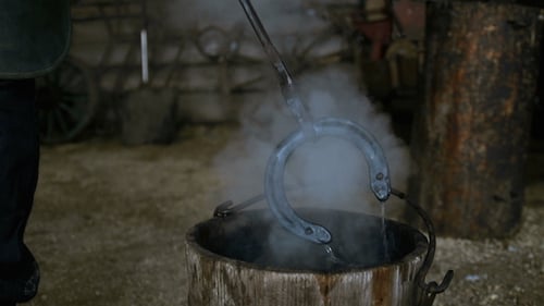 Blacksmith Quenching Hot Horseshoe in Water