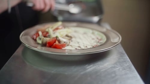 Chef Plating Steak and Vegetables Close Up