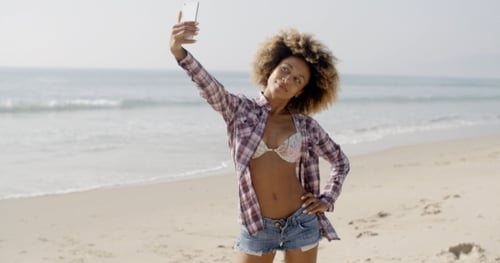 Woman Posing To Take A Selfie On The Beach