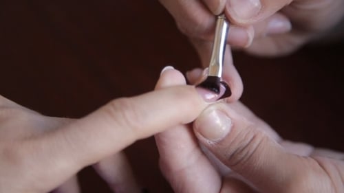 Black Nail Polish Applied to Fingernail in Macro