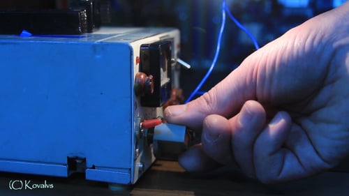 Hand Adjusting Dials on Electronic Testing Machine