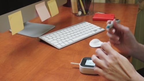 Woman Checking Blood Glucose Level With a Glucose