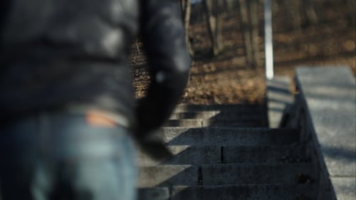 A Man Running Up The Stairs To The Street