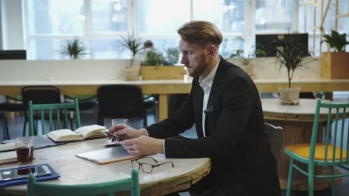 Multitasking Man Working In Modern Office