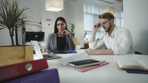 Employees Discussing Work In The Office