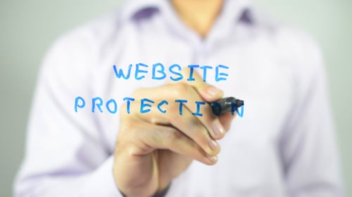 Hand Writes Website Protection with Blue Marker