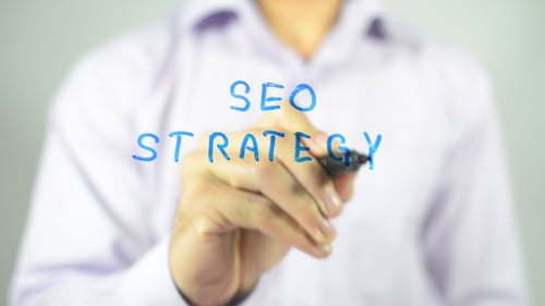Writing SEO Strategy on Clear Surface