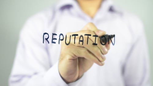 Writing Reputation with Black Marker on Glass