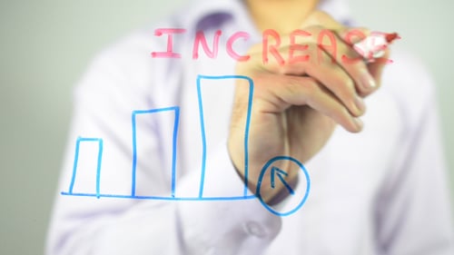 Hand Drawing Increase Chart on Glass Surface