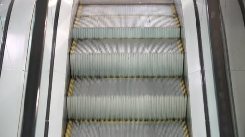 Escalator Moving Upward in Modern Urban Building