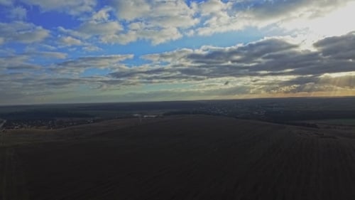 AERIAL: Flight Over The Wheat Field In Sunset