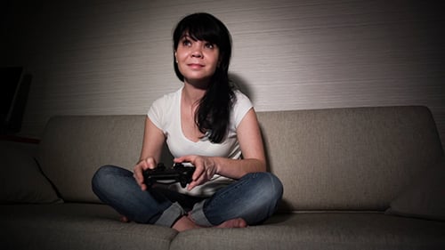 Young Woman Playing Video Games on Couch